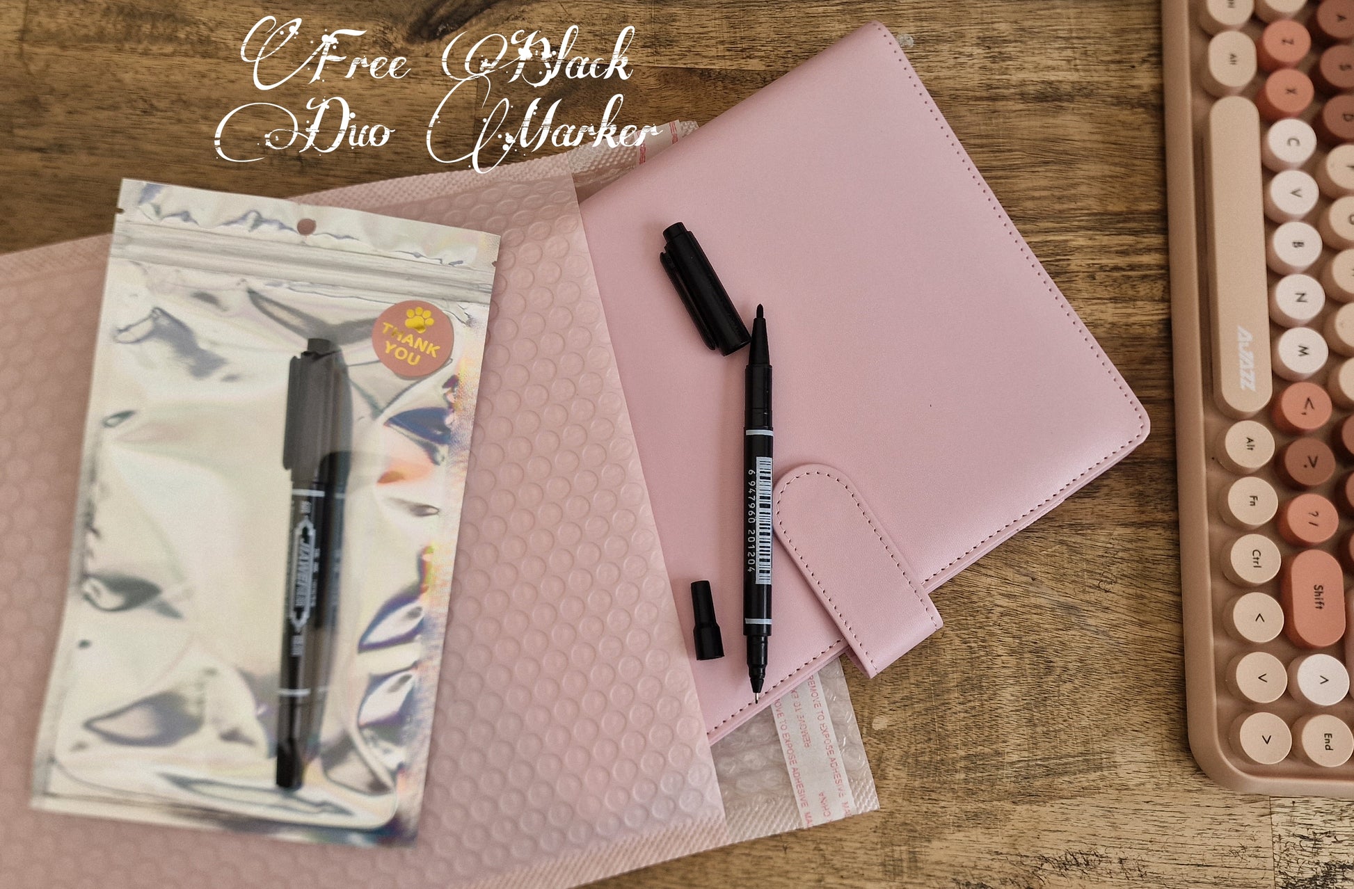 Pink binder with a free duo marker placed beside it.